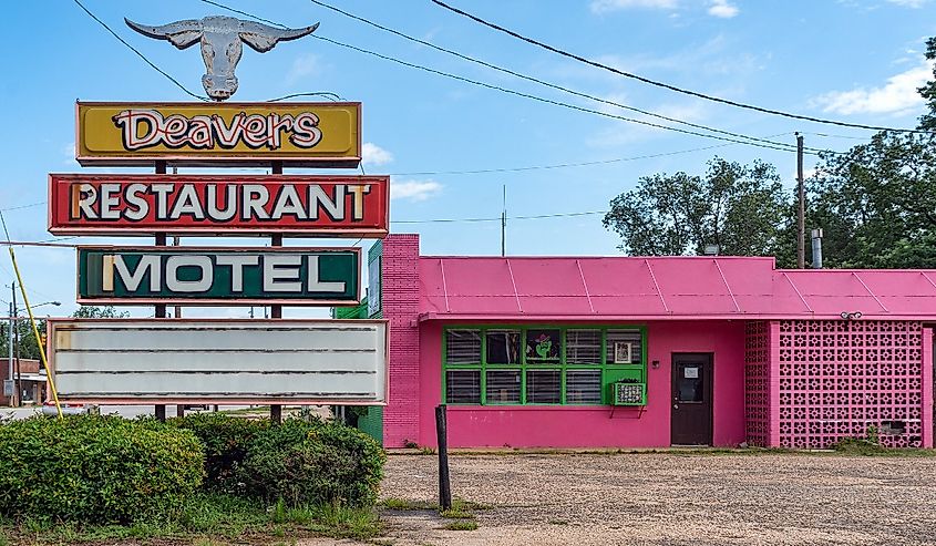 Bright pink facade of the Deavers Restaurant & Motel Grove Hill, Alabama.
