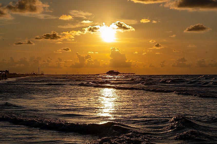 Sunset on Seawall beach in Galveston, TX.