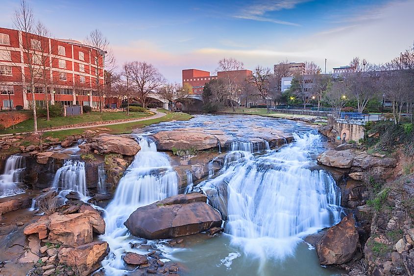 Reedy River Waterfalls run through the middle of downtown Greenville, South Carolina at Falls Park River Walk.