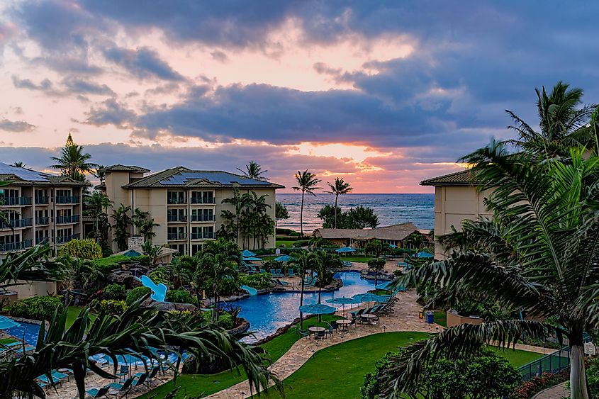 Sunrise over the ocean at a resort at Waipouli Beach with pool in the foreground