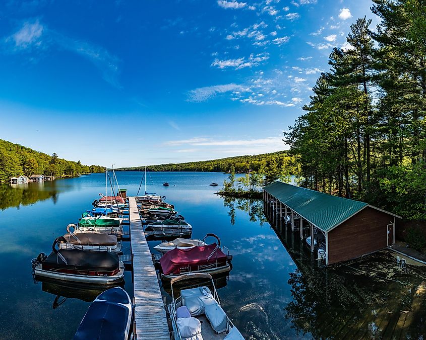 Boats are moored near a waterfront café on a calm summer day in Rye New Hampshire