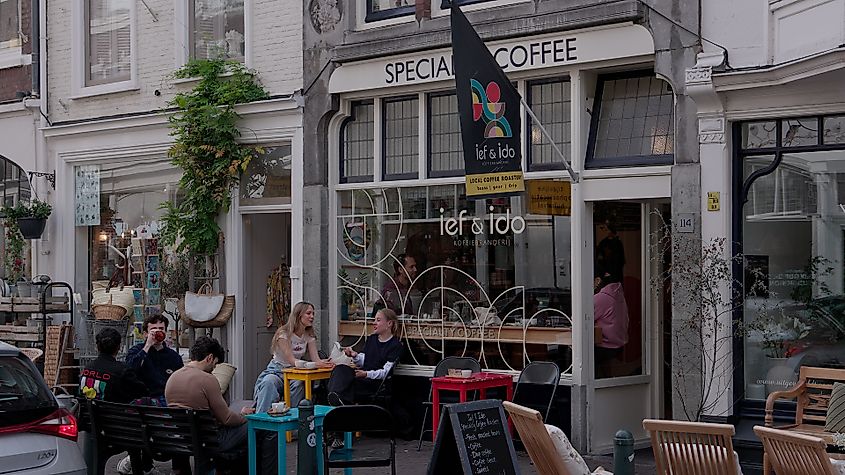THE HAGUE, NETHERLANDS - SEPTEMBER 14, 2025 - People relaxing and drinking coffee at an outdoor cafe in The Hague, Netherlands
