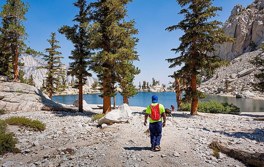 A hiker approaches Lone Pine Lake on the trail to Mount Whitney