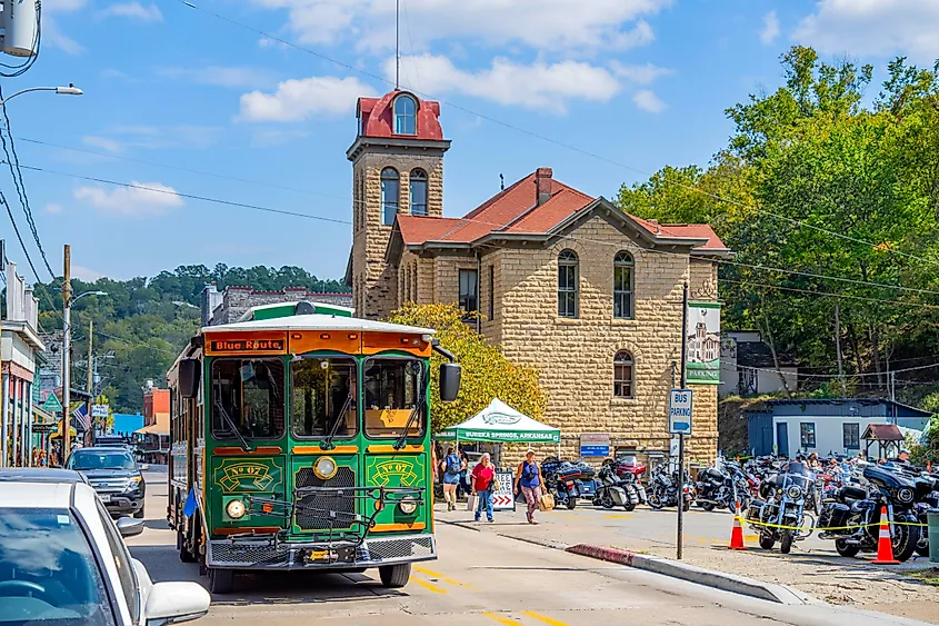 A vintage trolley moving through downtown Eureka Springs, Arkansas. Image credit: Kit Leong / Shutterstock.com.