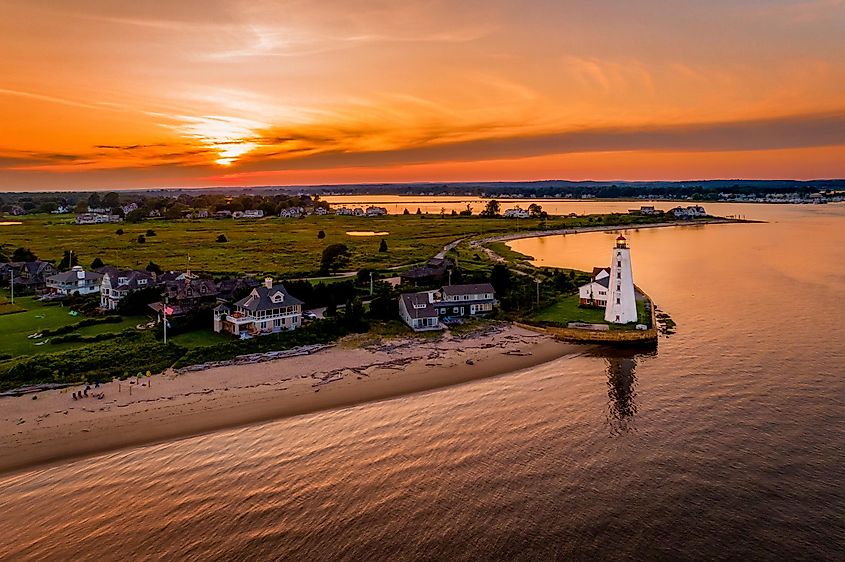 Summer sunset in Old Saybrook along the Connecticut River with Lynde Lighthouse in the foreground and a summer sunset