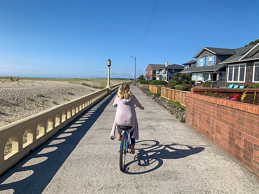 Woman biking on the Promenade in Seaside, Oregon