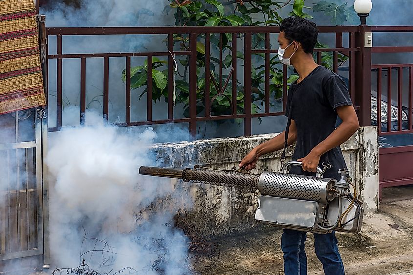 People fogging DDT spray kill mosquito for control Malaria, Encephalitis, Dengue and Zika in village at Bangkok Thailand.