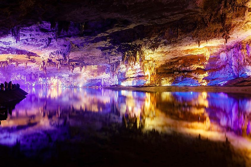 A scenic inside view of the Shuanghedong Caves with colorful lights