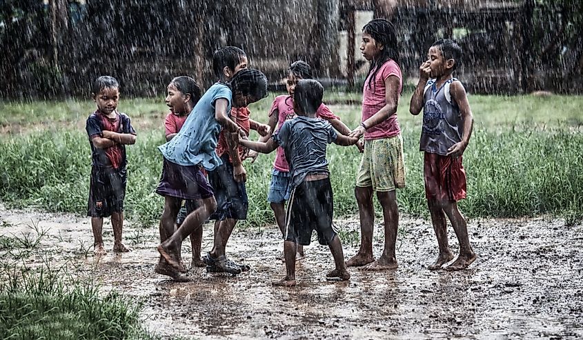 Indigenous children in Panama playing in the rain.