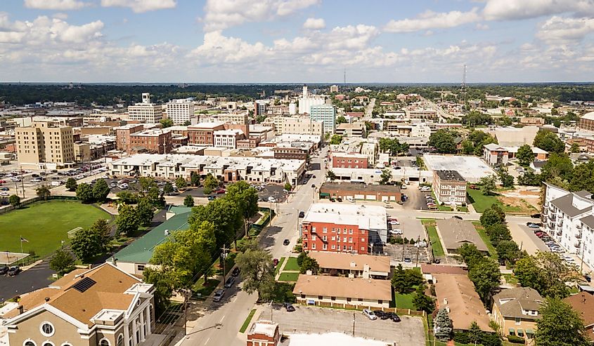 The downtown city skyline and buidlings of Springfield Missouri under partly cloudy skies aerial perspective