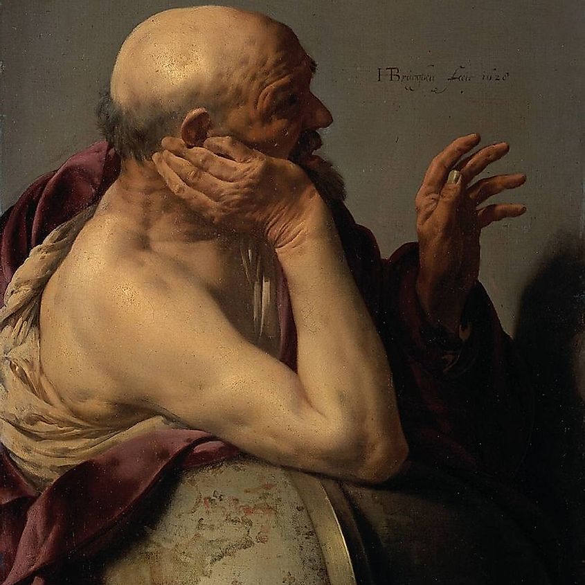 Heraclitus, talking and gesturing while he is leaning on a globe with his right arm.