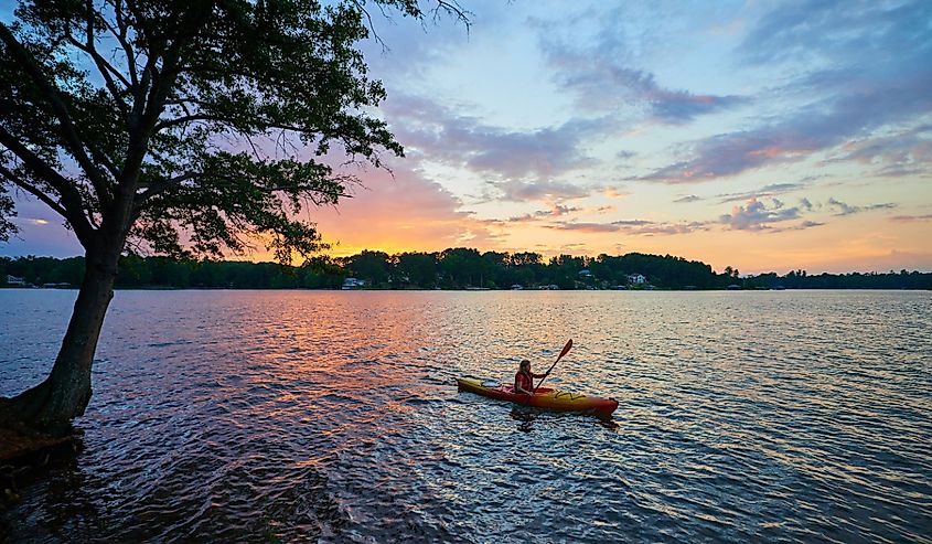 Female kayaker on Lake Keowee at Sunset