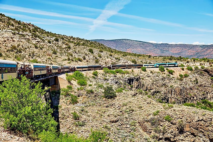 Verde Canyon Railroad train crossing bridge on scenic route in Clarkdale, Arizona, USA.