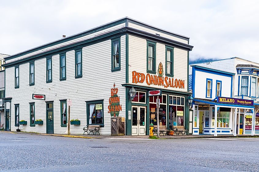 Editorial Photo Credit: Debbie Ann Powell via Shutterstock. Skagway, Alaska - September 28 2017: Red Onion Saloon, a bar and brothel museum, popular place for cruise ship passengers and other tourists in the city of Skagway, Alaska.