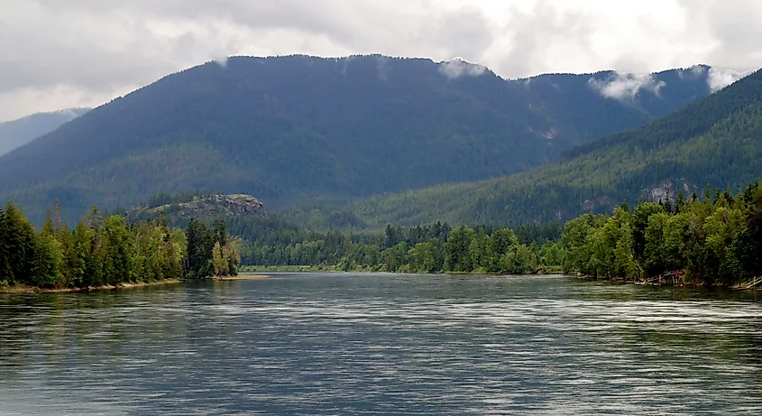 Clark Fork River in Idaho, winding through a scenic landscape of forests and mountains.