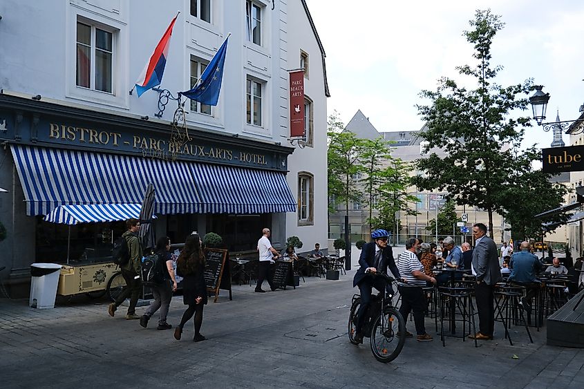 People sit on the terrace of a cafe during a sunny day in the center of Luxembourg city on June 7, 2023.