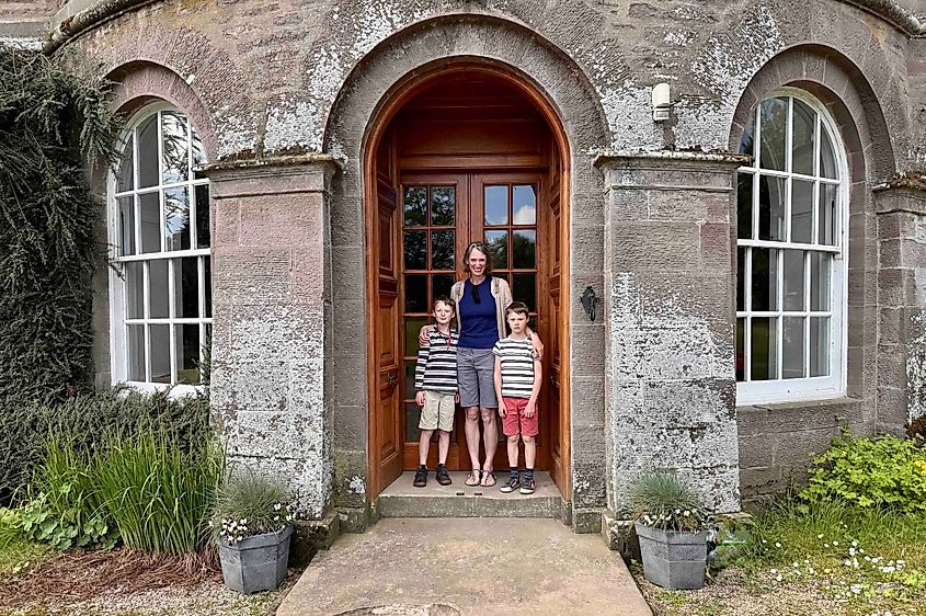 Alex and boys Charles (left) and Henry in front of Monzie Castle Image credit Bryan Dearsley