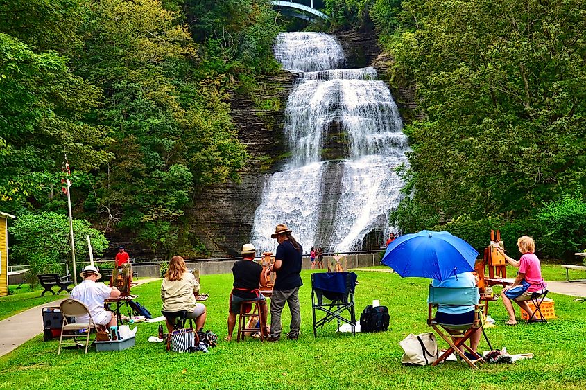 Montour Falls, NY, US- August 29, 2021: A group of grown up students attending an art painting class, in the Shequaga Falls Park. Continued education, art school, people concept 