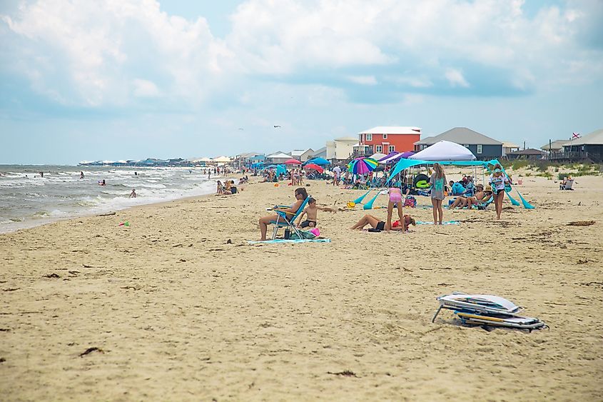 A busy summer beach day in Dauphin Island, Alabama. Editorial credit: HarrisonJeffs / Shutterstock.com.