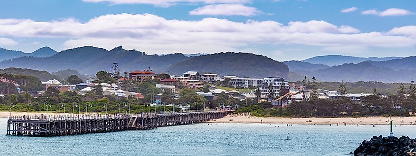 Panoramic landscape of Coffs Harbour jetty and luxury real estate.