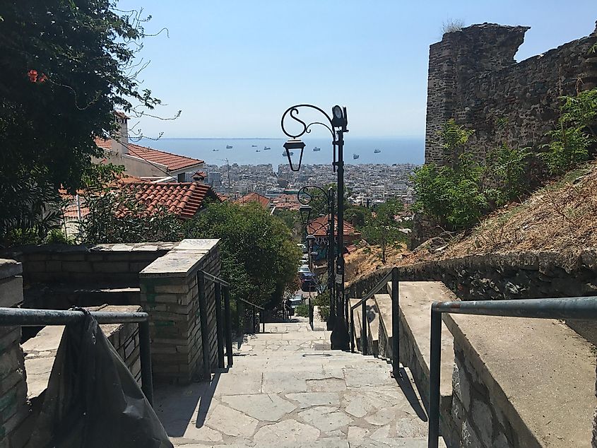 A stone staircase leads down to the many layers of Thessaloniki, and eventually, to the waterfront (seen far in the distance). 