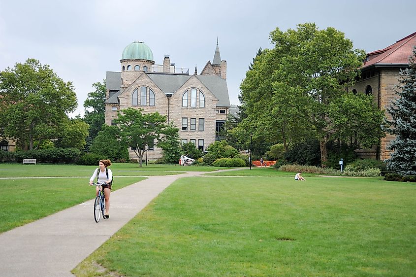 An Oberlin student rides her bicycle through the main quad in front of Peters Hall at Oberlin College, via PICTOR PICTURES / Shutterstock.com