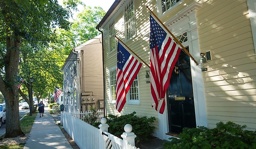 American flags and a white picket fence line Main Street in Essex, an all-American village.