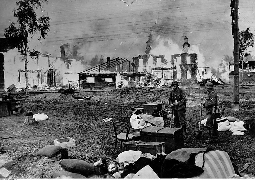 German soldiers in front of burning houses and a church, near Leningrad in 1941