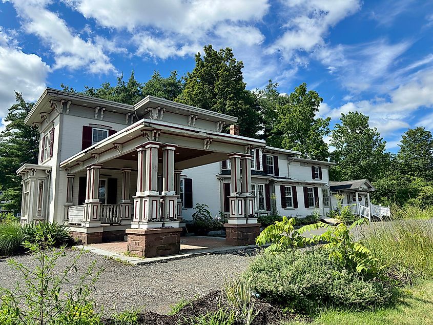 Historic building in the district with overgrown vegetation around the driveway