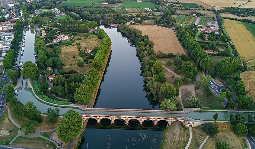 Aerial top view of river, canal du Midi and bridges from above, Beziers town, South France
