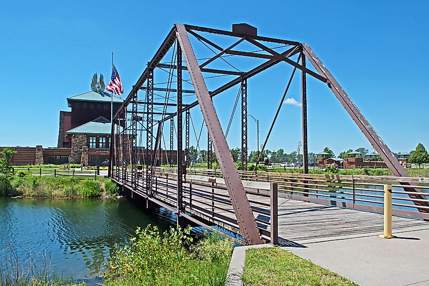 Kearney, NebraskaUSA - June 7 2019: the Archway Monument viewed from across the river with an old metal bridge in the foreground.
