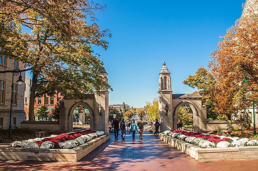  University of Indiana - Family walks with college student out main gates of campus down into the town during Fall Break weekend, via Vineyard Perspective / Shutterstock.com