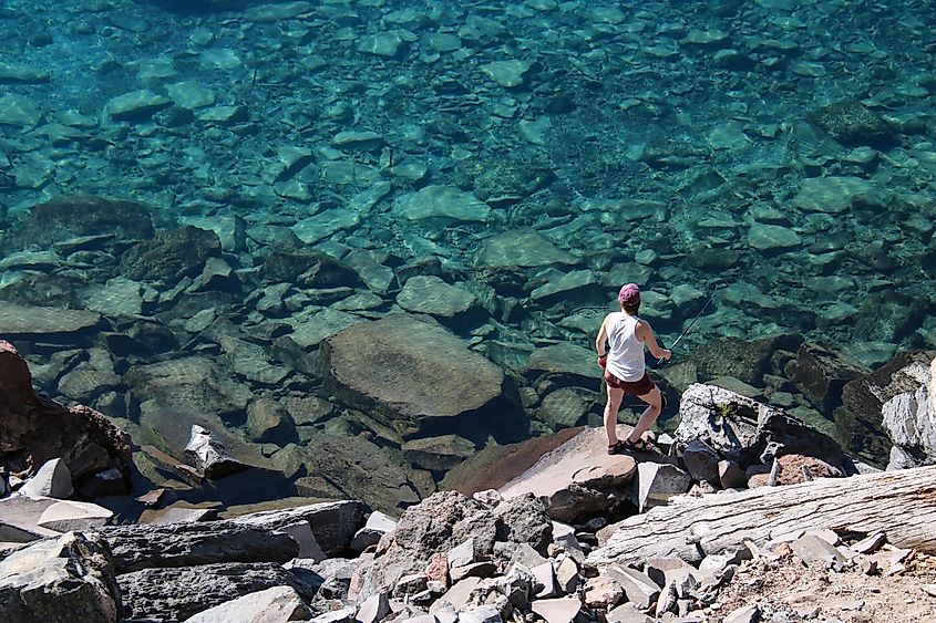 A person fishing in Crater Lake, Oregon