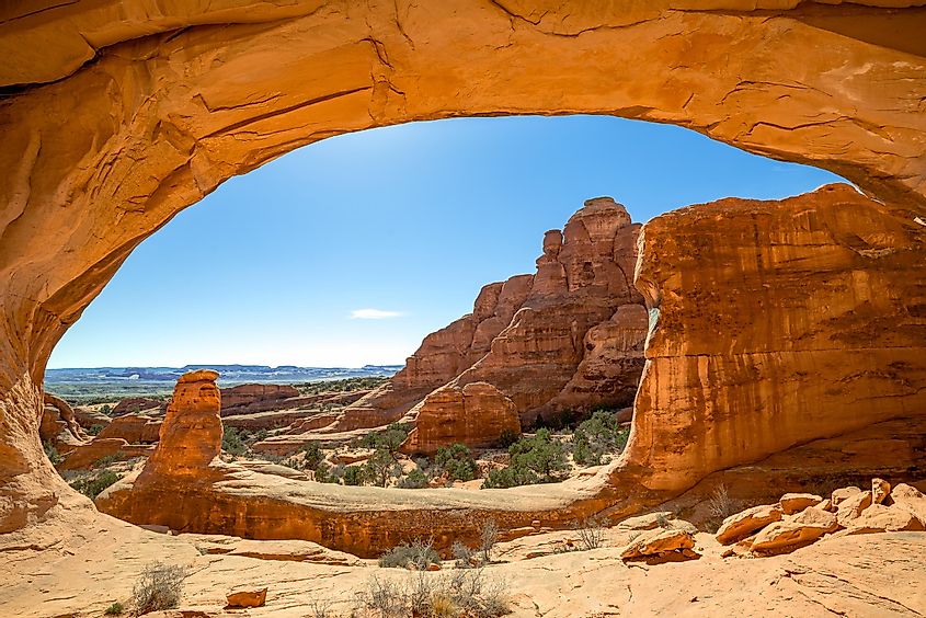 USA, Utah, Grand County, Arches National Park, Klondike Bluffs. A scenic view with Tower Arch framing the zig zag hiking trail to get to it.