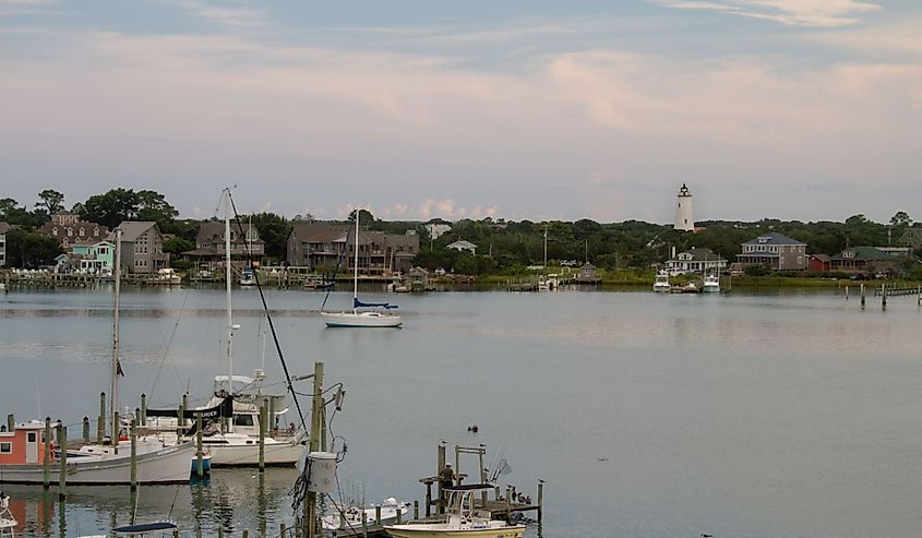 Ocracoke Island Lighthouse, and recreation and fishing boats in Silver Lake Harbor, Ocracoke Village, Outer Banks, North Carolina