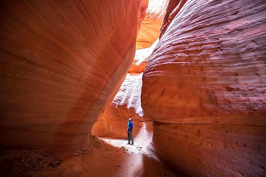 Person standing in the Slot canyon in Grand Staircase Escalante National park, Utah, USA. 