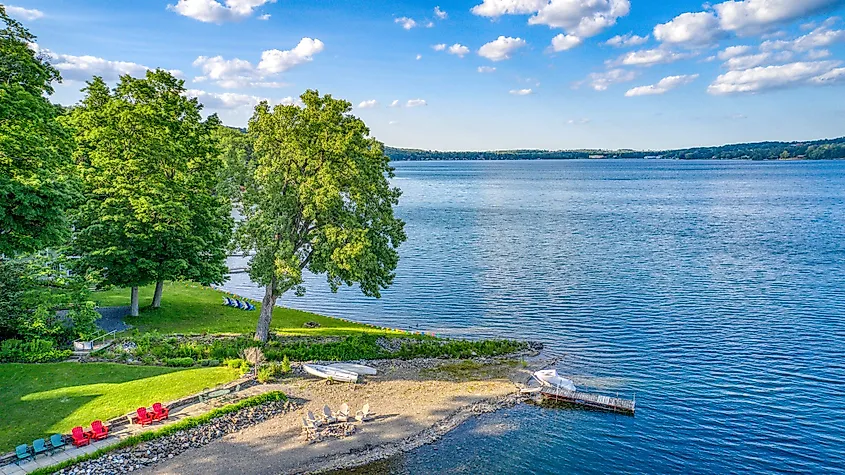 Keuka Lake is surrounded by green trees in Hammondsport, New York.