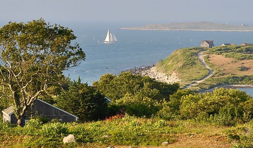 Trail on Cuttyhunk Island with a sailboat in the background