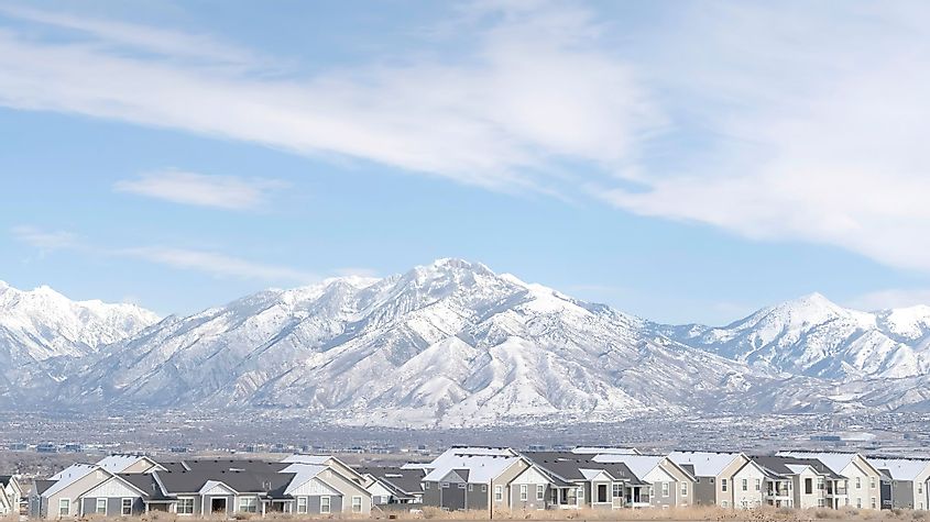 Panorama frame striking Wasatch Mountains and South Jordan City in Utah during winter season