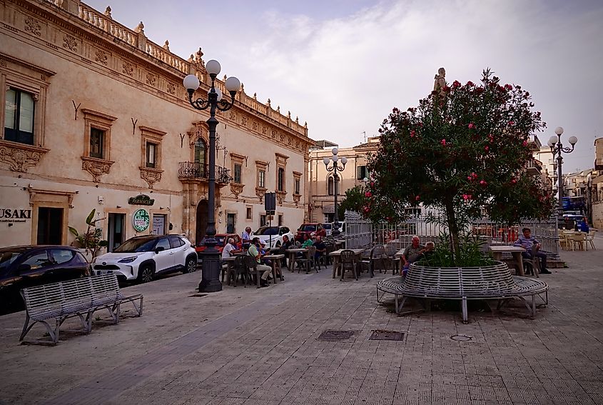 People in a square in Scicli, Sicily.