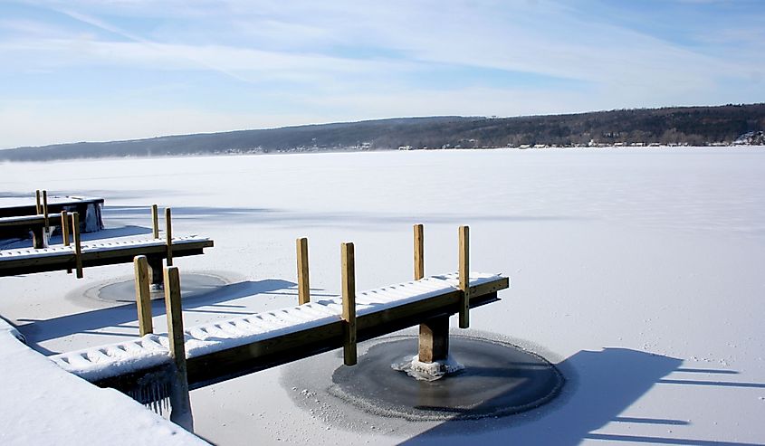 View of snow covered piers on frozen Keuka Lake in the Finger Lakes area of New York.