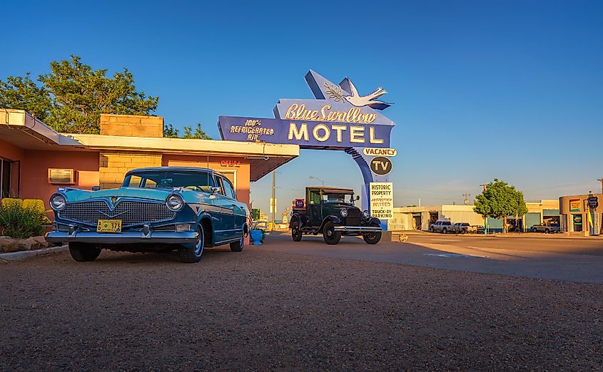 Historic Blue Swallow Motel with vintage cars in Tucumcari, New Mexico.