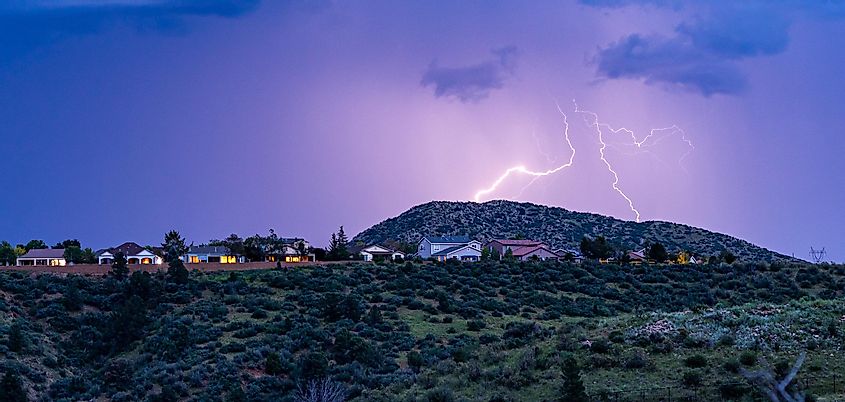 Lightning striking above houses in Prescott Valley, Arizona.