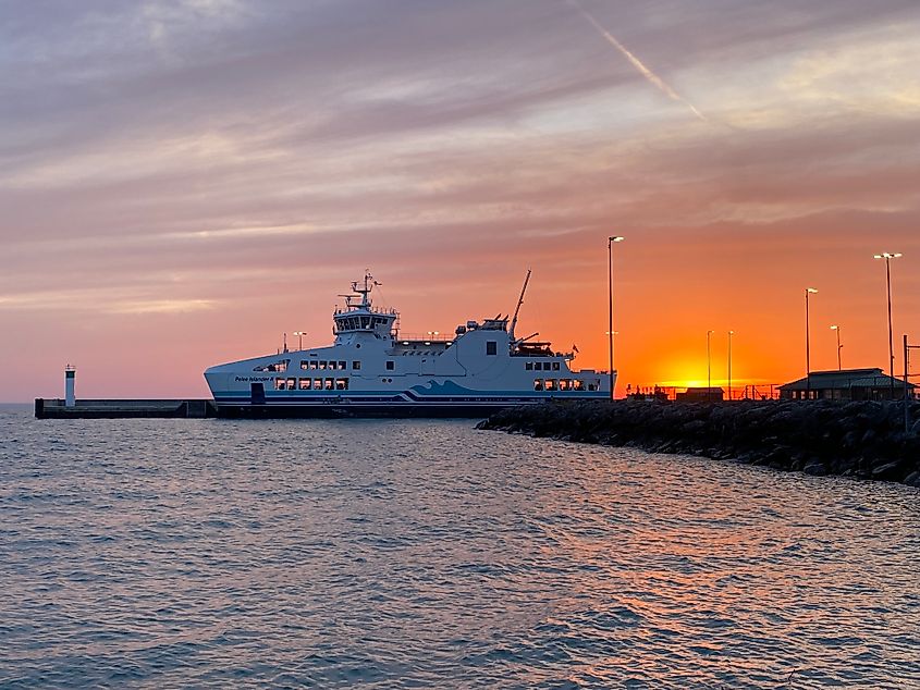 A beautiful late sunset behind a docked ferry boat.
