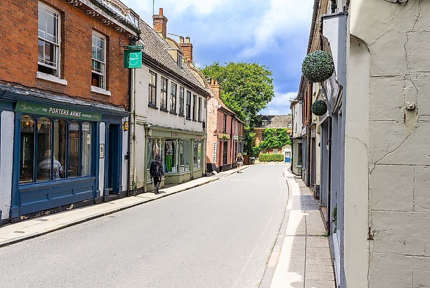 Shopfronts and people in small town England.