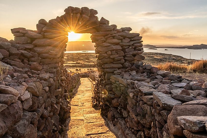 Sunset view of a stone gateway on Pachatata hill on Amantani island in Titicaca lake, Peru. Credit: Matyas Rehak/Shutterstock.com