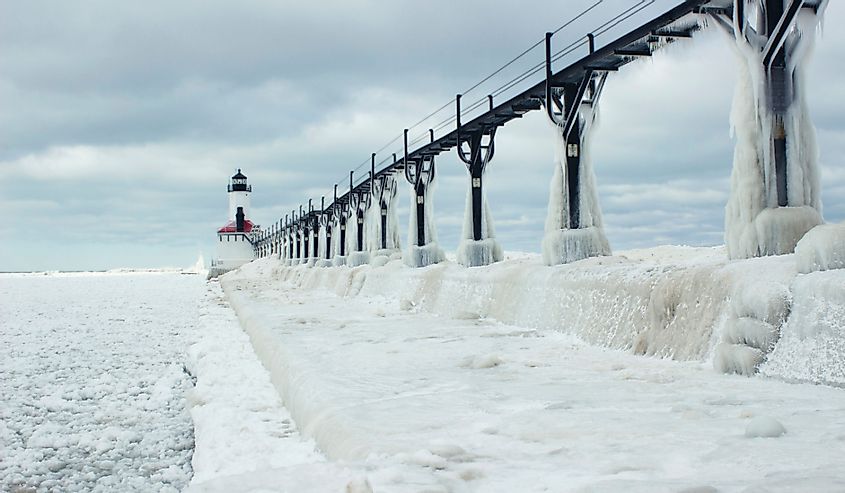  Michigan City, Indiana lighthouse and pier in Ice and snow surrounded by frozen lake Michigan