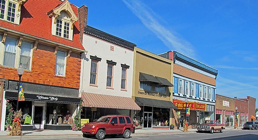 Cars and storefronts along The 100 block of North Main Street in Greenville, Kentucky.