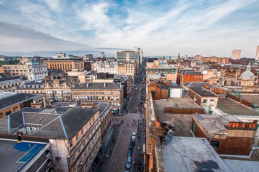 A wide view looking down on a street, buildings and rooftops in Glasgow city center, Scotland, United Kingdom