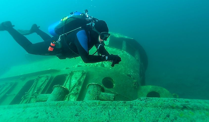 Diver exploring a shipwreck in Grand Island Harbor Bay